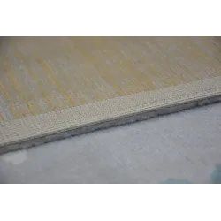 Alfombra de jardín en gris y crema con detalles turquesa